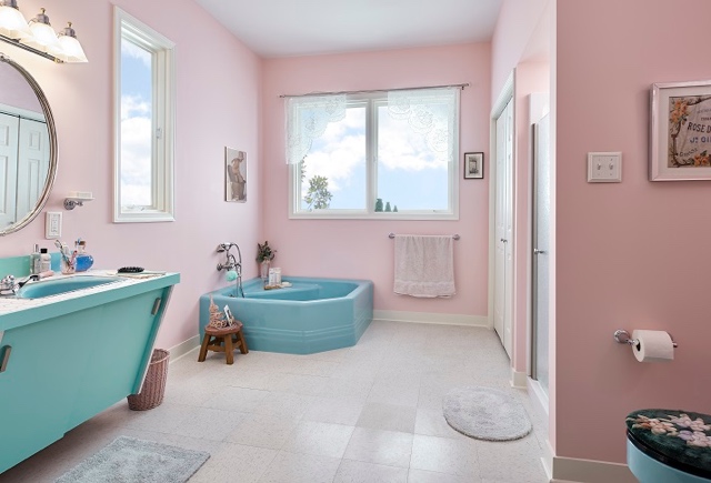 A bathroom with pink walls and a tub

Description automatically generated