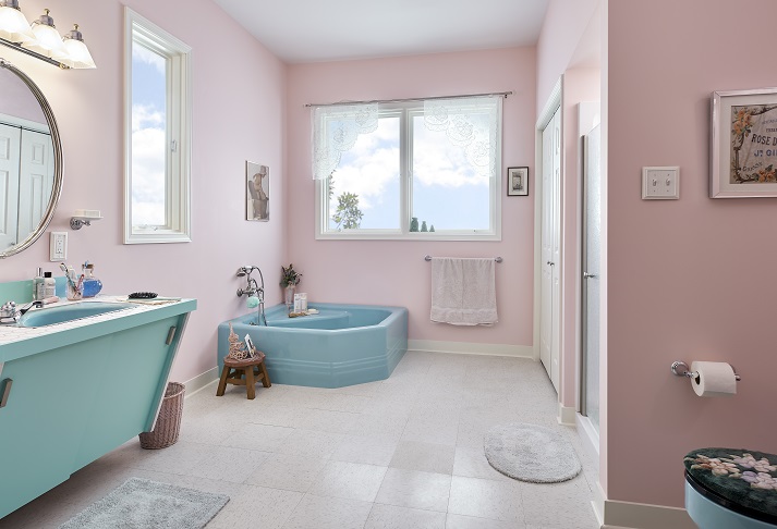 A bathroom with pink walls and a tub

Description automatically generated