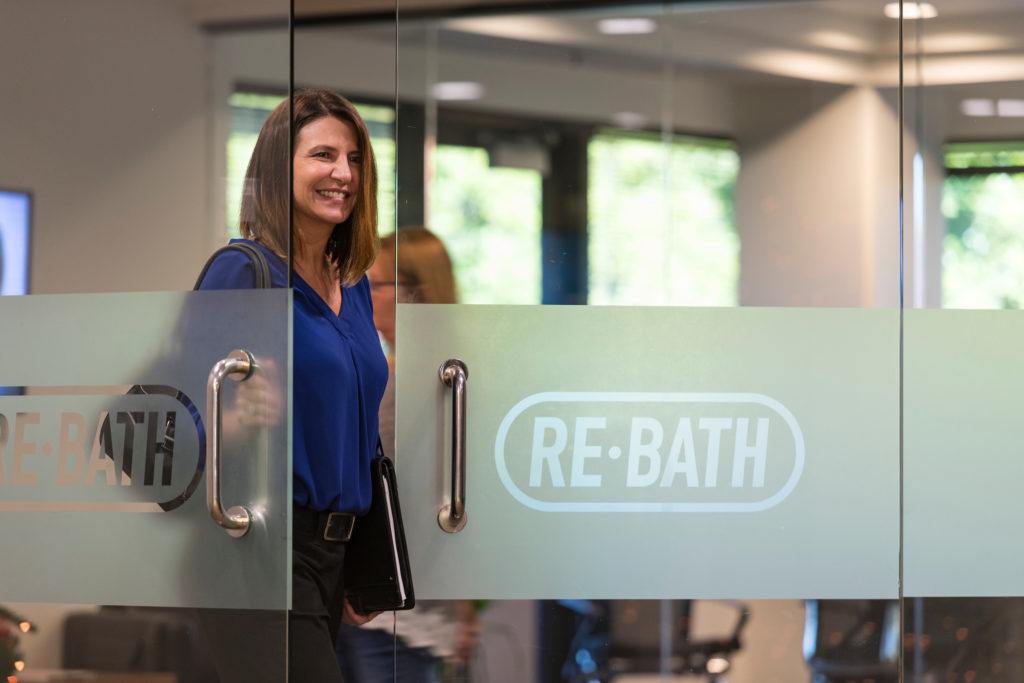 woman opening door in office